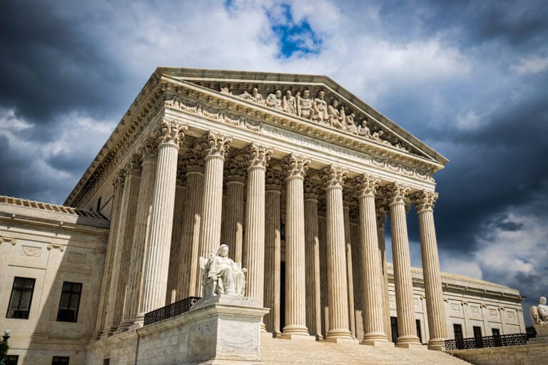 The supreme court building with an overcast sky, where oversight case law is discussed.