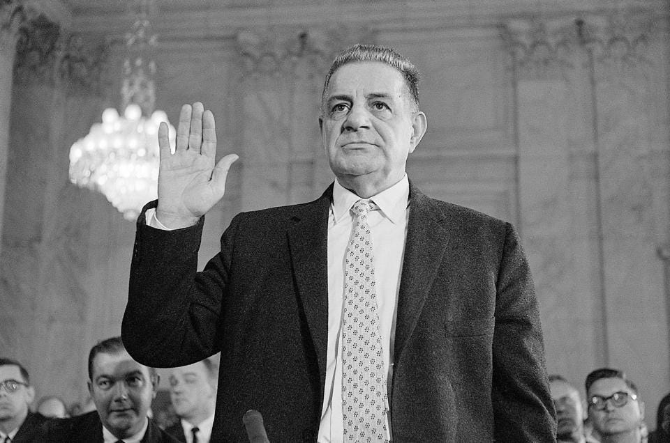 Valachi being sworn in with his right hand raised